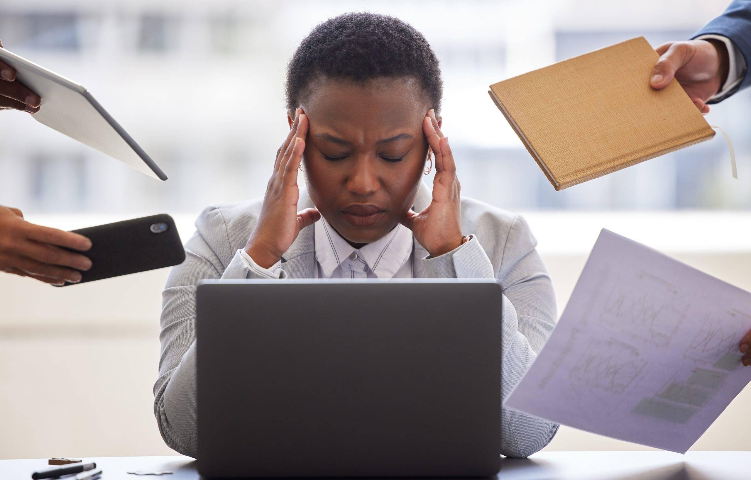 Shot of a businesswoman looking overwhelmed in a demanding office environment. Why is therapy important? It helps to unburden my mind.